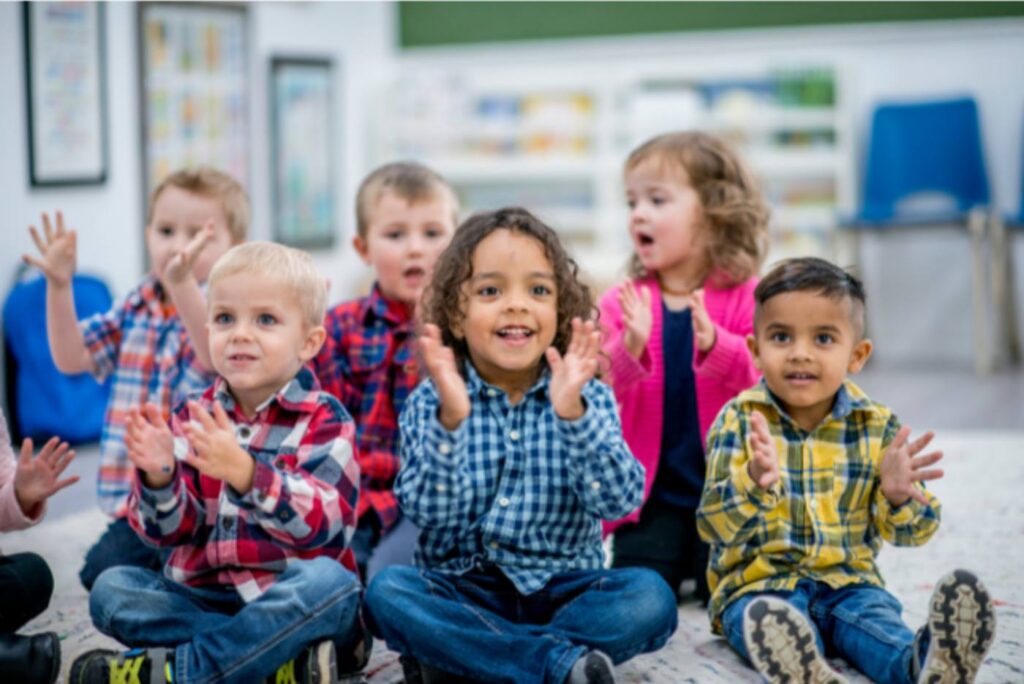 A group of children clapping